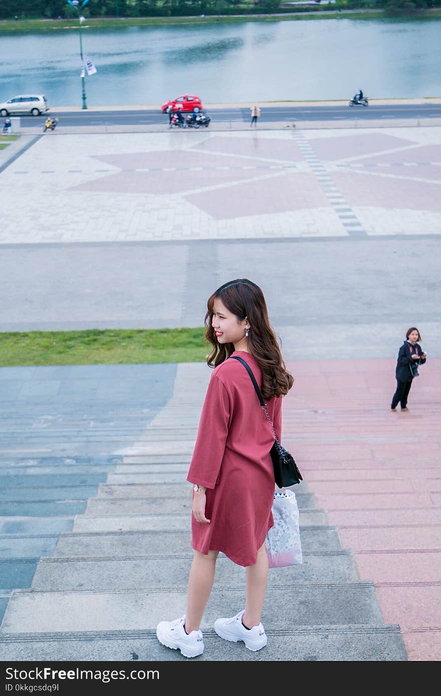 Woman Wearing Red Clothes and Pair of White Running Shoes