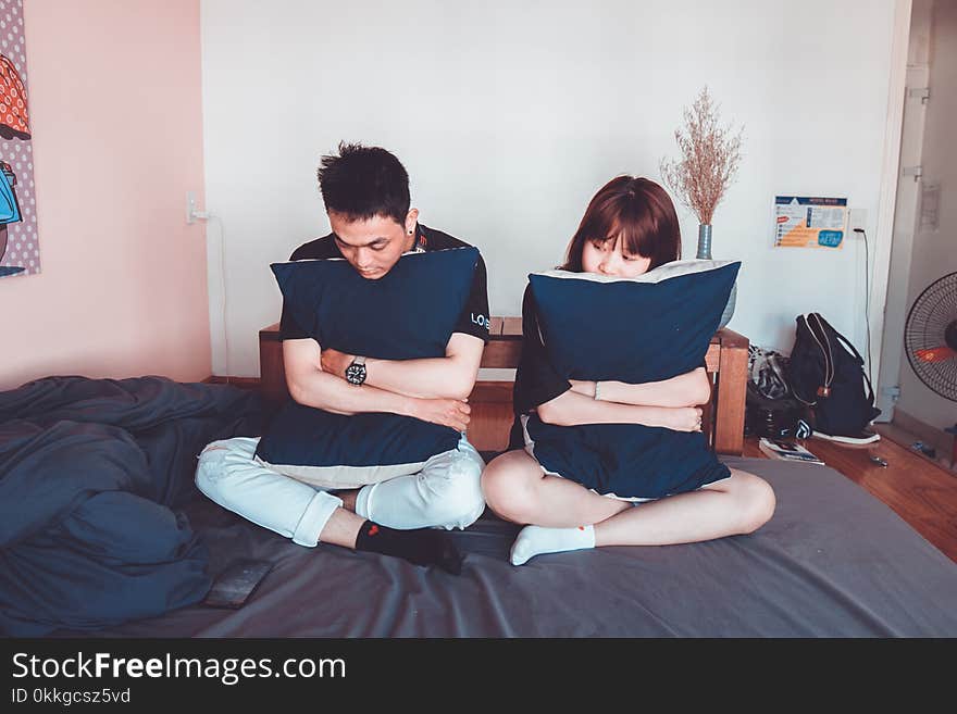 Man and Woman Sitting on Bed