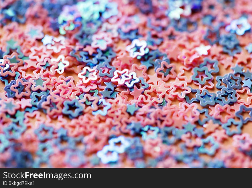 Shallow Focus Photography of Pink and Blue Star Figures