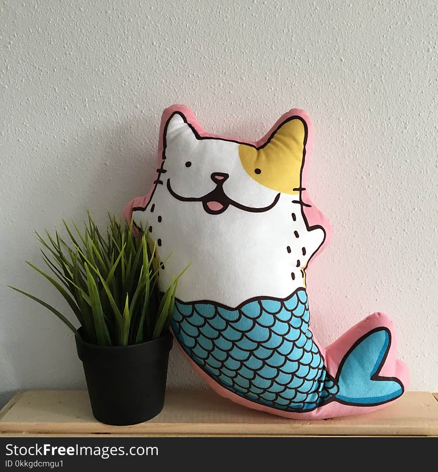 Mermaid Cat Pillow Beside Plant