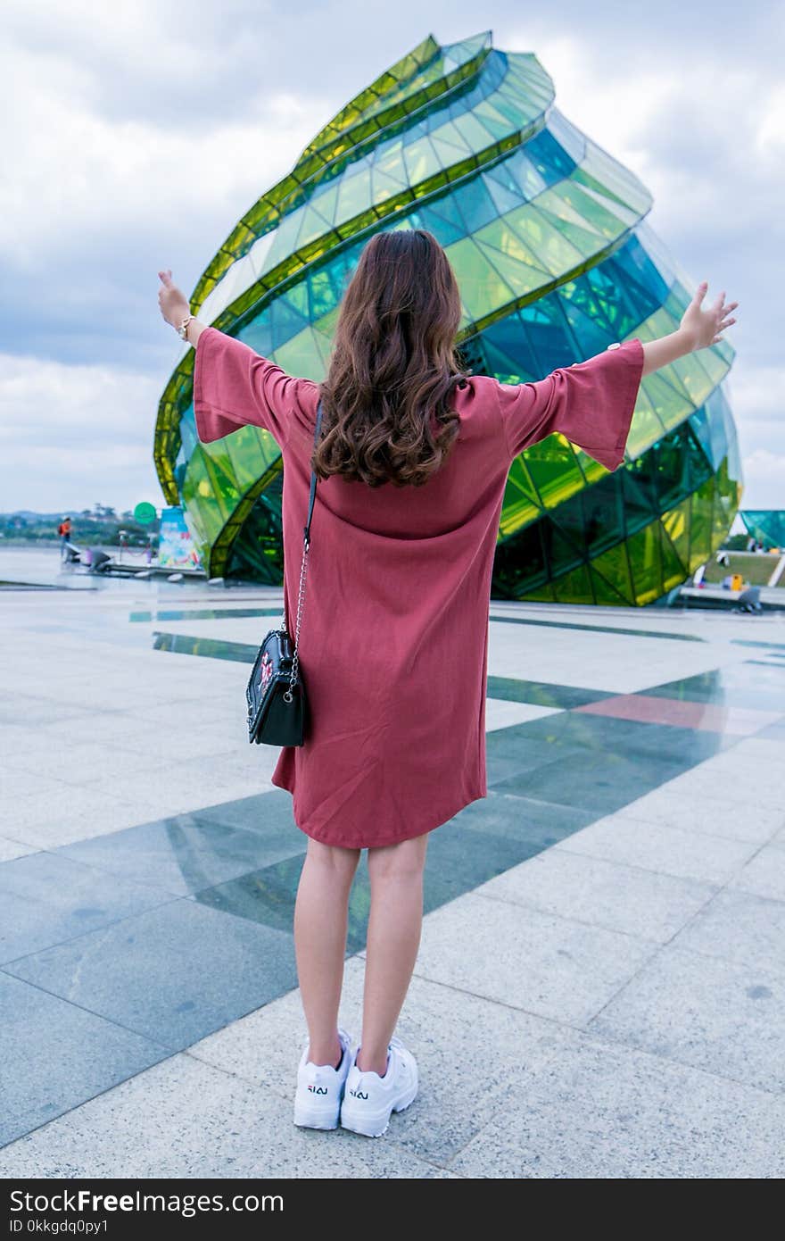 Woman Standing In-front of Glass Building