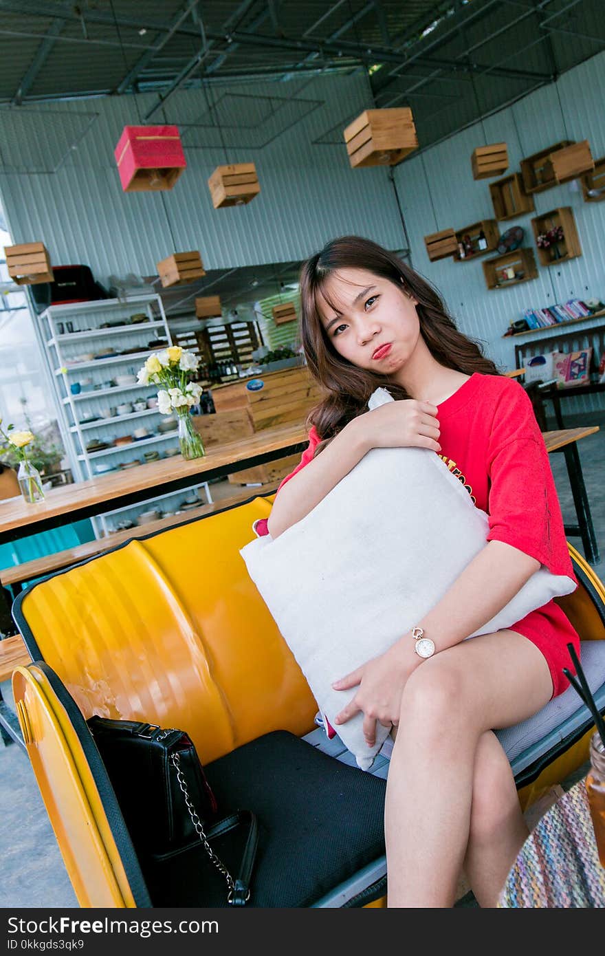 Woman Sitting on Yellow Couch