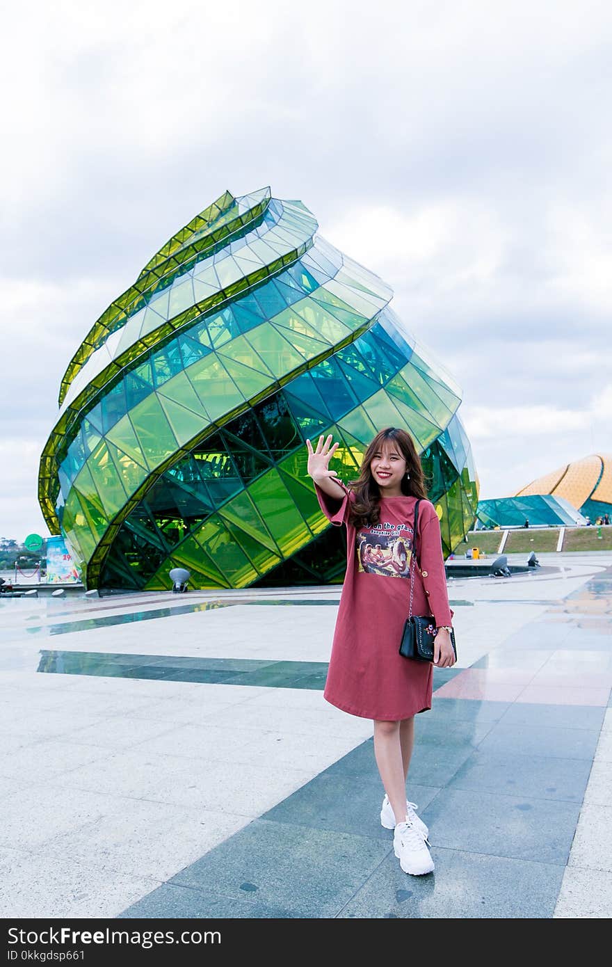 Woman in Front of Green Glass Building