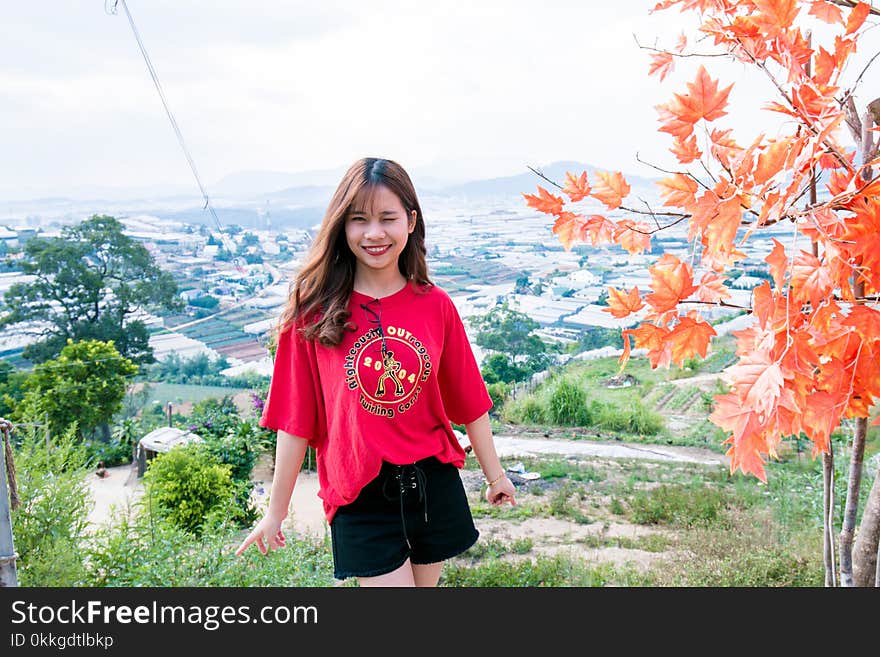 Woman in Red T-shirt and Black Shorts