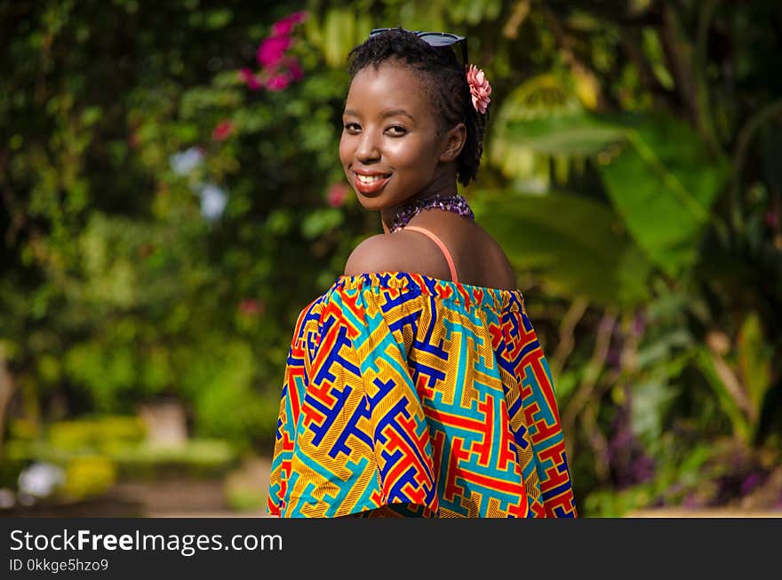 Shallow Focus Photography of Woman Wearing Multicolored Off-shoulder Top