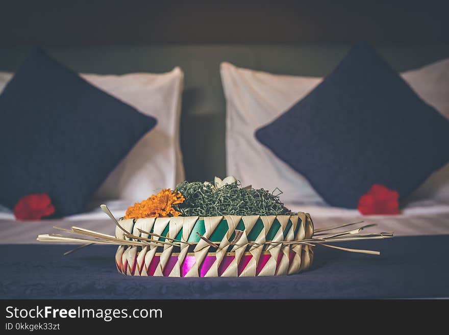 White and Green Table Decoration Near Two Black Pillows