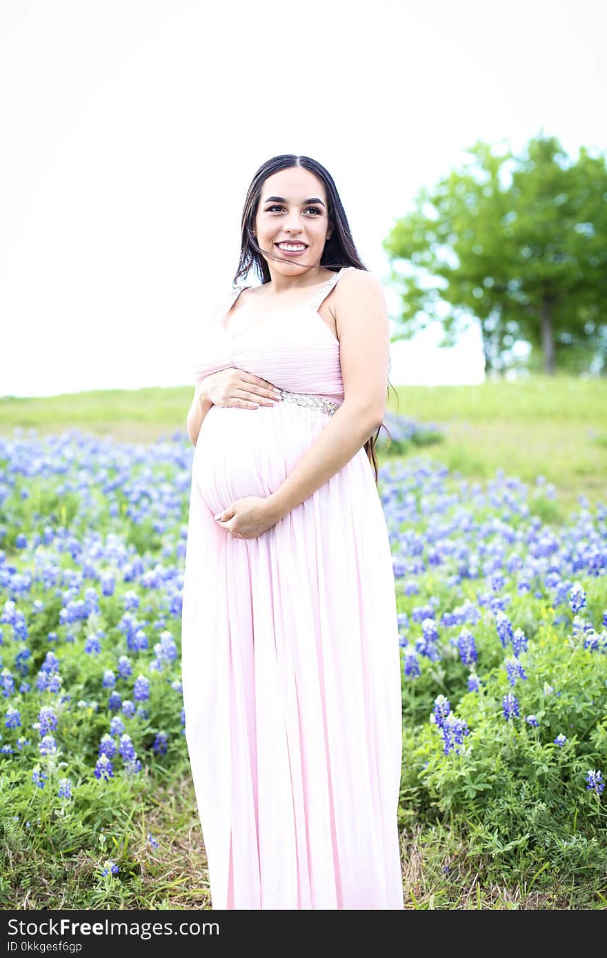 Pregnant Wearing Pink Dress Surrounded With Lavender