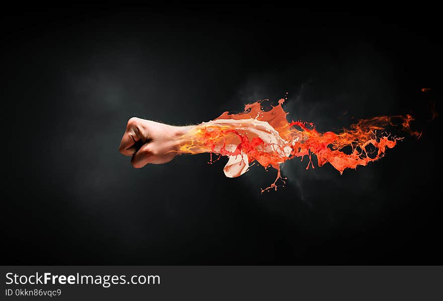 Close of male fist in fire flames. Close of male fist in fire flames