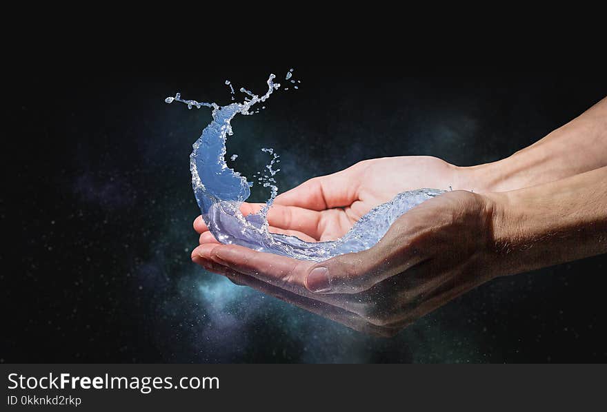 Close of person hands holding water splashes. Close of person hands holding water splashes