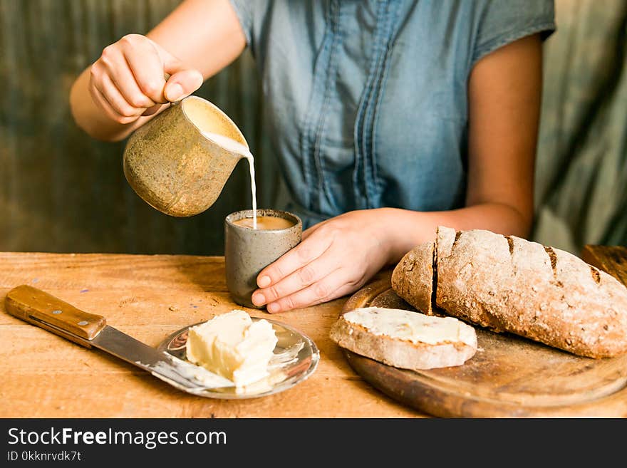 Woman Has Breakfast Adds Milk To Coffee