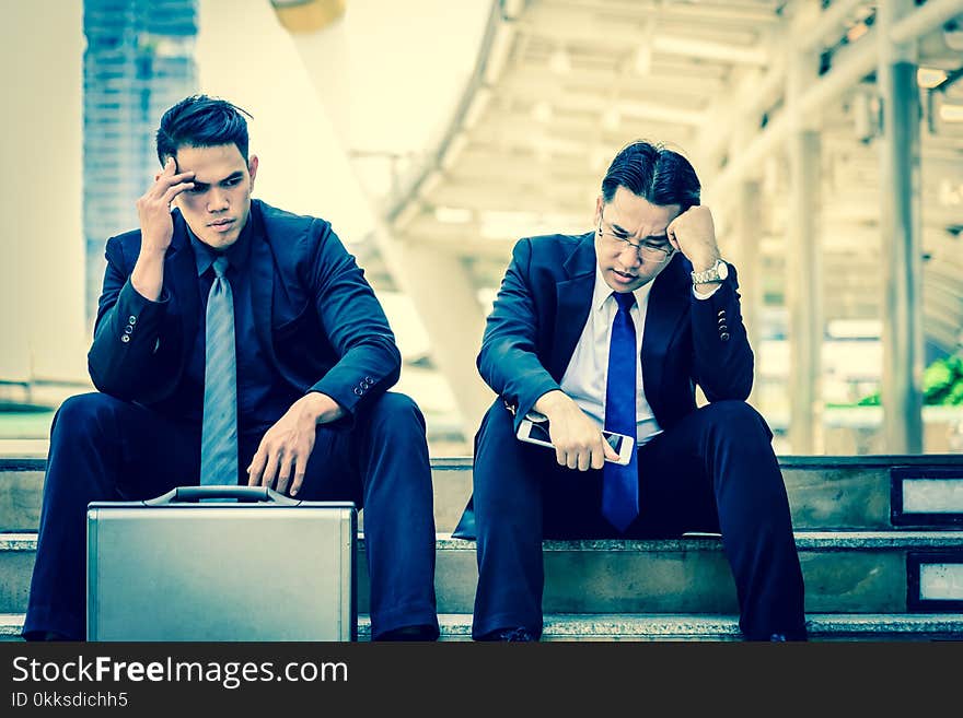 Two asian Businessman feel sad and frustrated upset fail in life