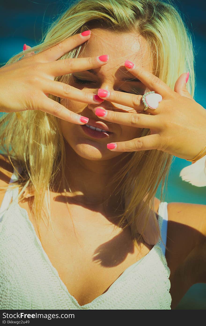 Pretty young blonde pretty girl at beach cover head with hands. Woman fashion have active time in summer. Summertime carefree concept. Pretty young blonde pretty girl at beach cover head with hands. Woman fashion have active time in summer. Summertime carefree concept.