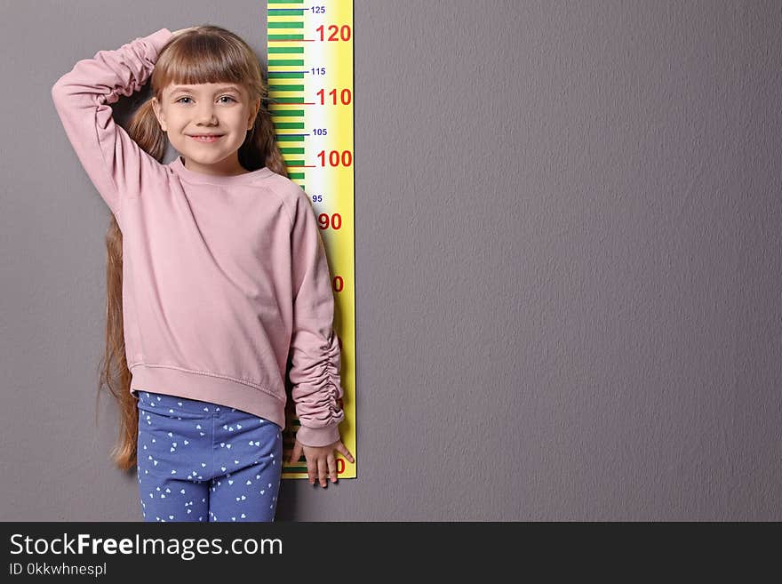 Little girl measuring her height