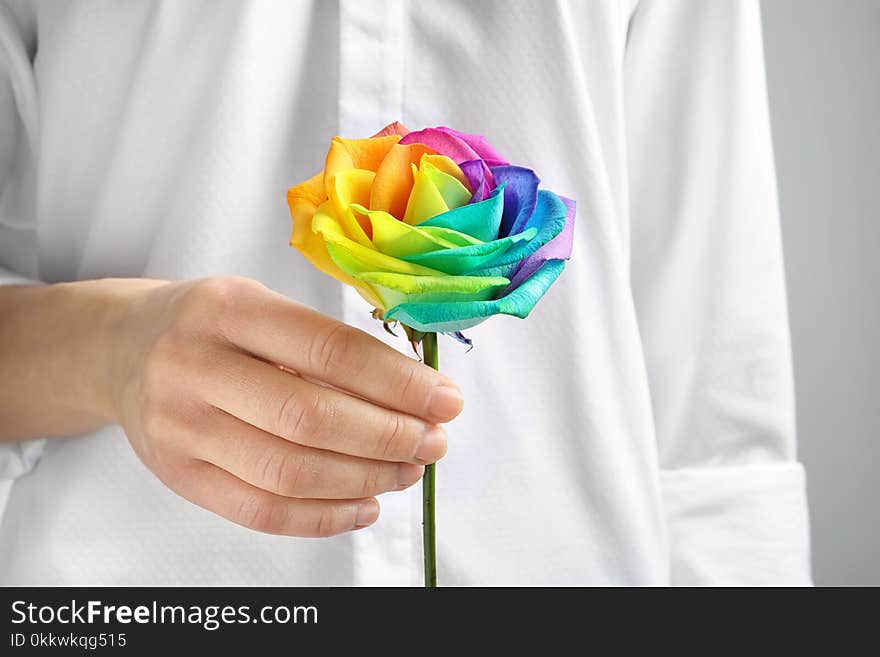 Woman holding rainbow rose flower