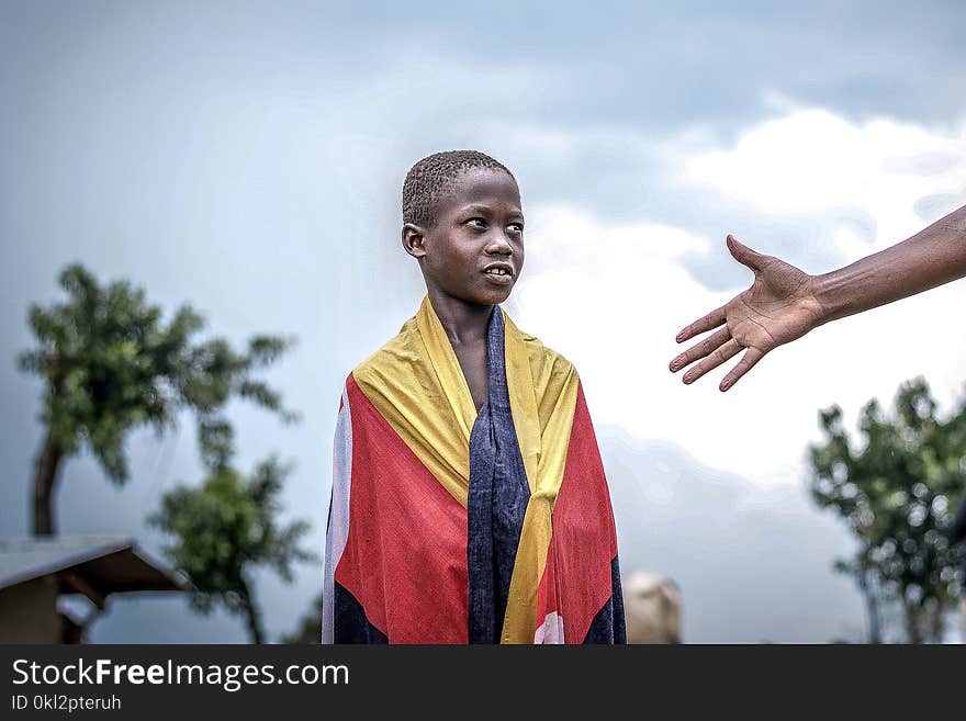 Person Wearing Red and Yellow Textile