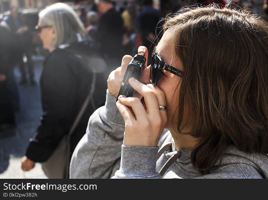 Woman Holding Point-and-shoot Camera With Gray Jacket