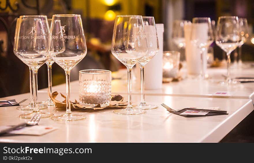 Clear Wine Glasses on White Wooden Table