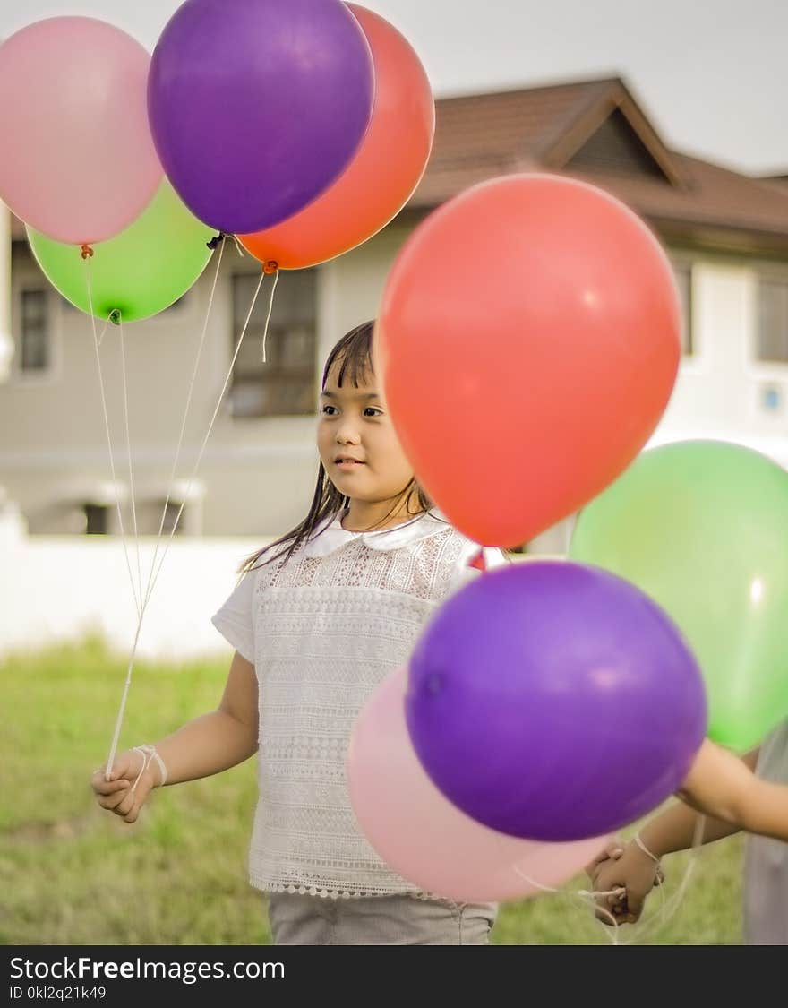 Photography of a Girl Holding Balloons