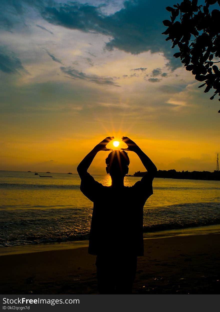 Silhouette Photo of Person Raising Hands