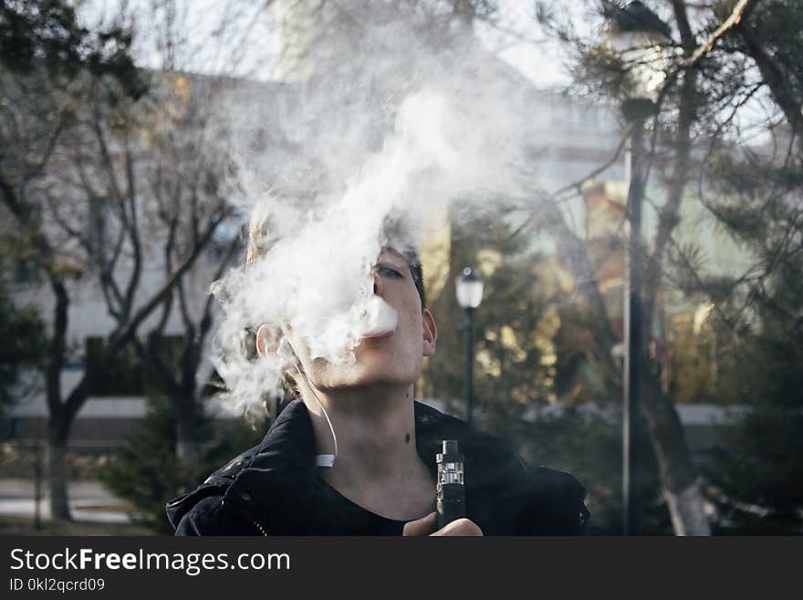 Photography of a Man Using Vape