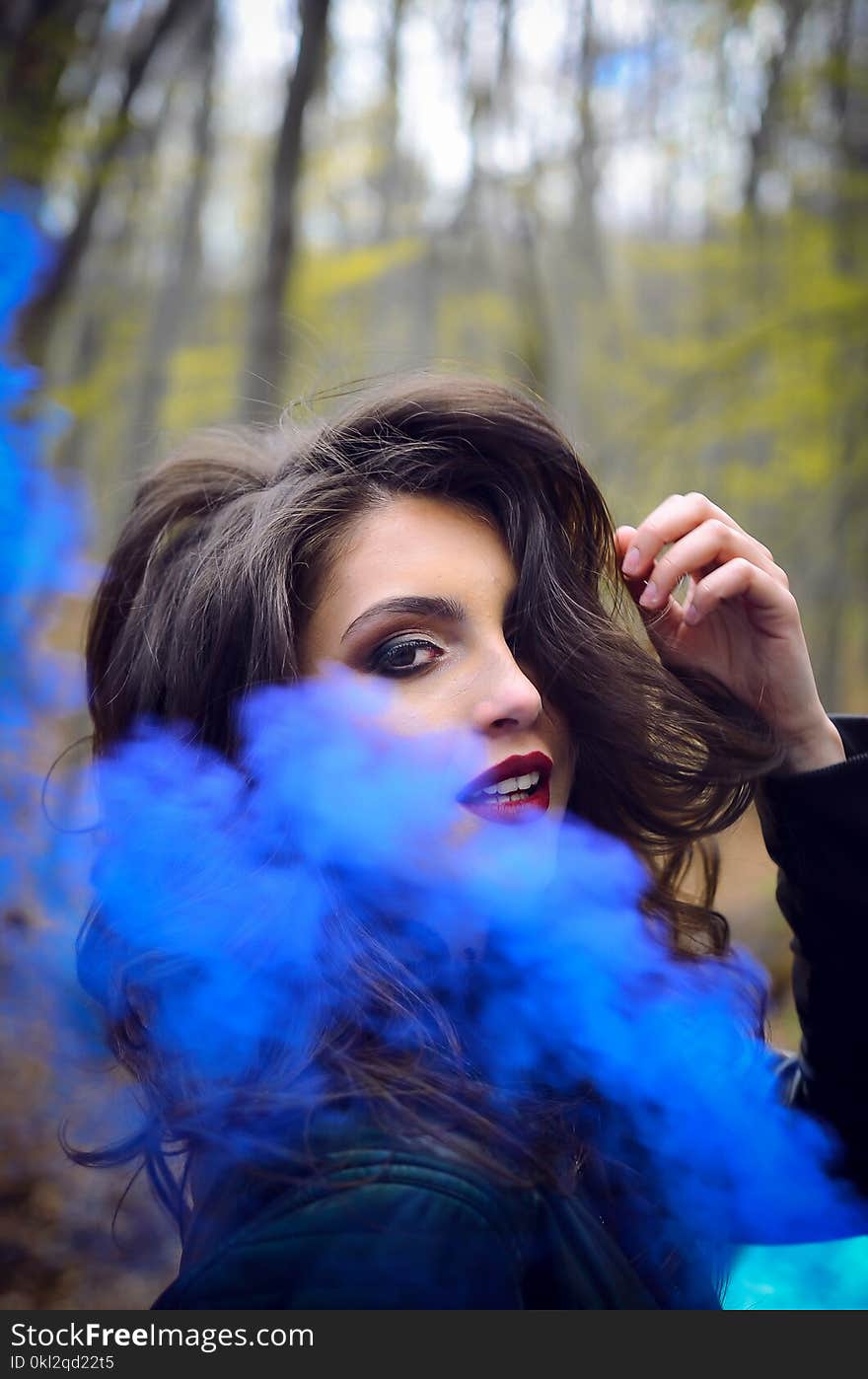 Close-Up Photography of a Woman Near Blue Smoke