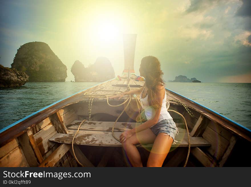 Woman Wearing White Tank Top Seating on Boat