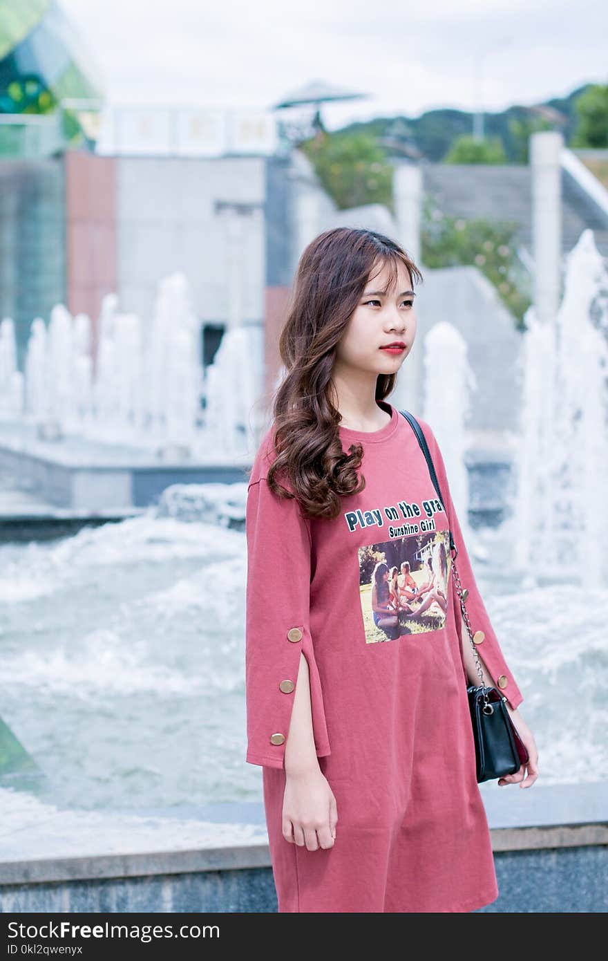 Woman Wearing Red Dress Near Fountain