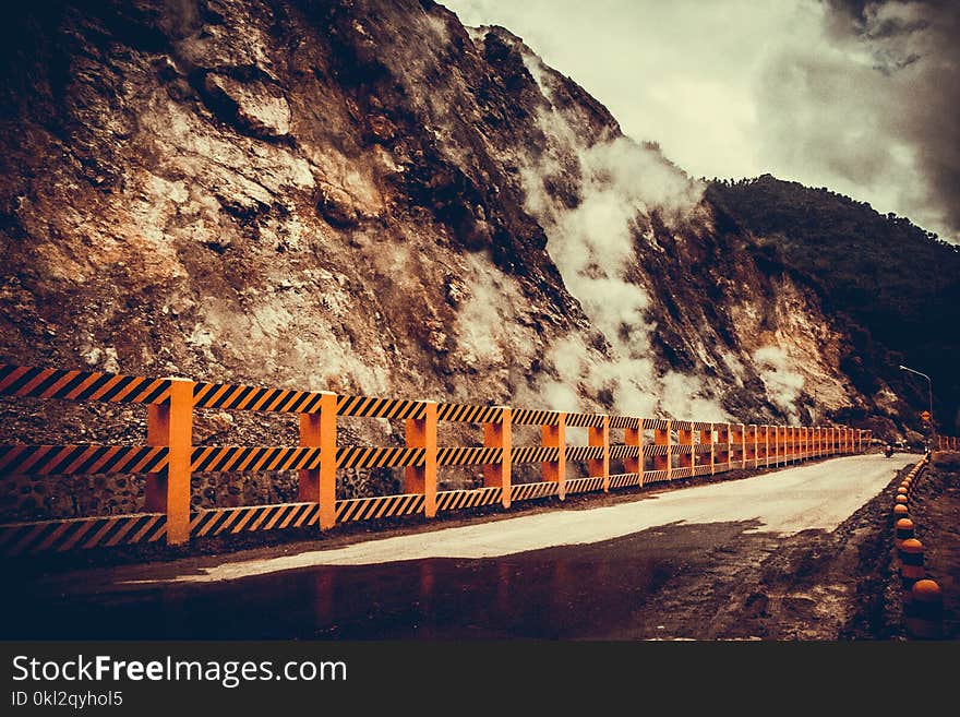 Concrete Road Near Mountain at Daytime