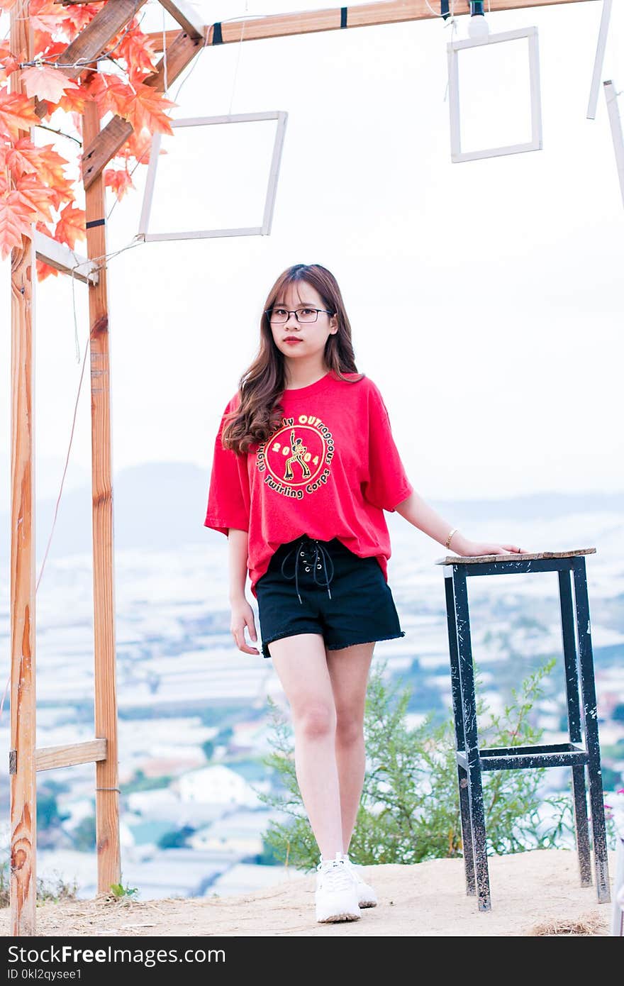 Woman Wearing Pink Scoop-neck Top and Black Shorts