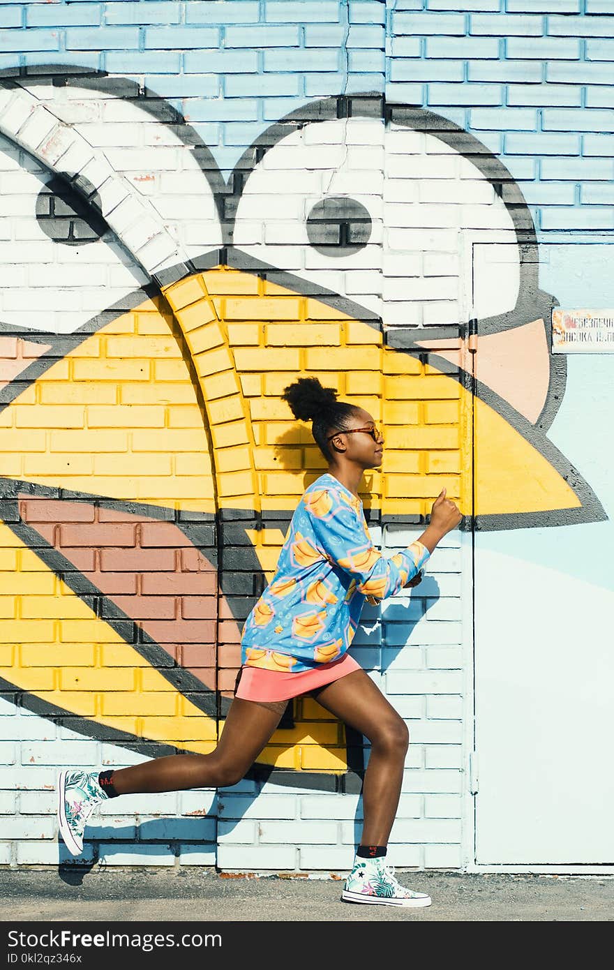 Woman Wearing Blue and Yellow Long-sleeved Top and Pink Skirt