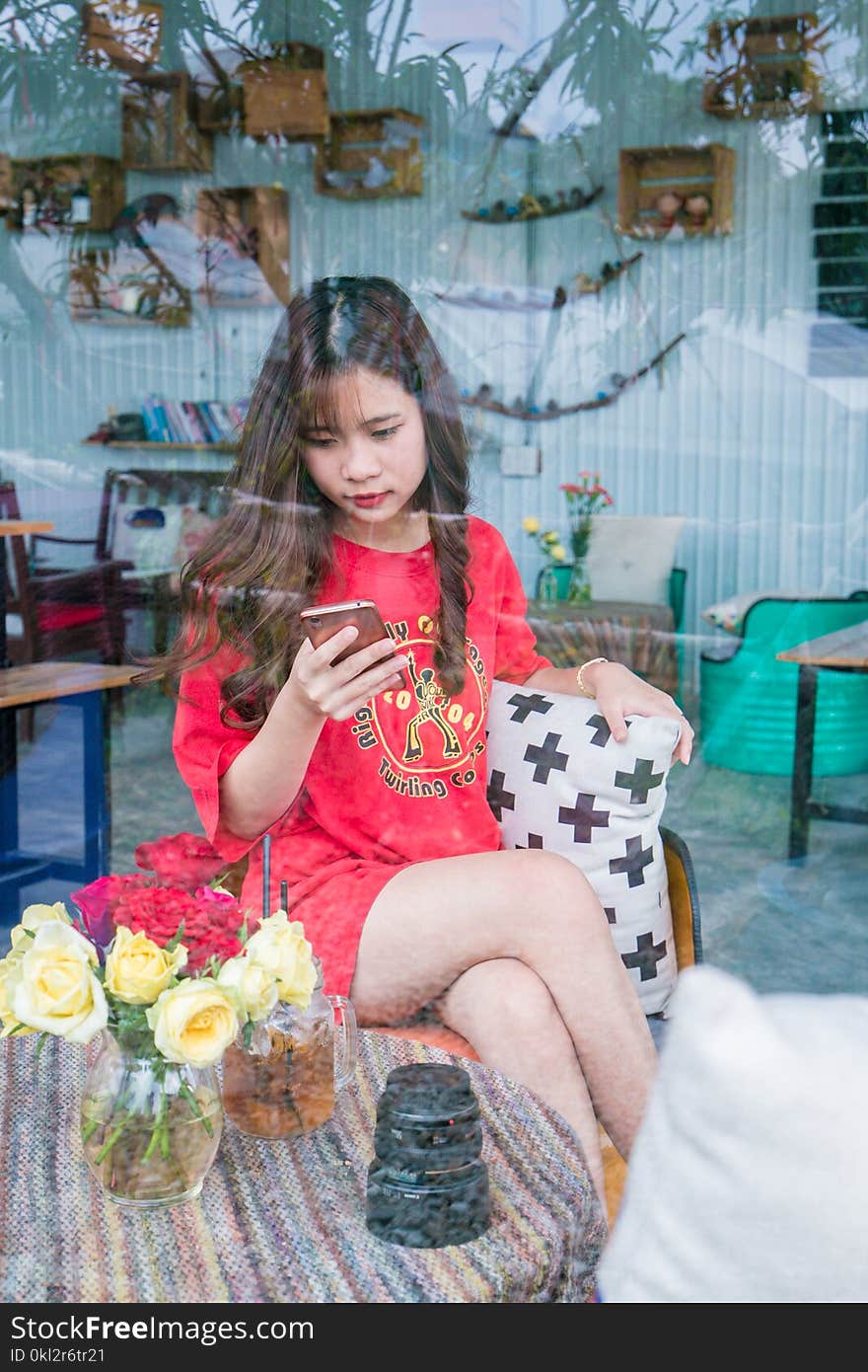 Woman Using Smartphone Sitting on Chair