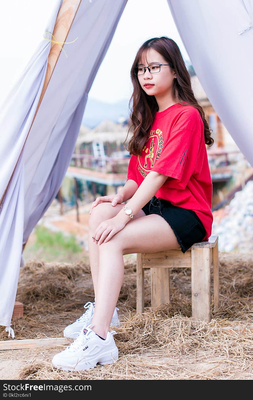 Woman in Red T-shirt and Black Denim Shorts