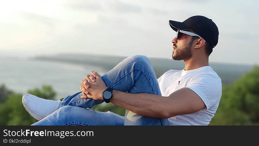 Photo of Man in White Crew-neck T-shirt Sitting