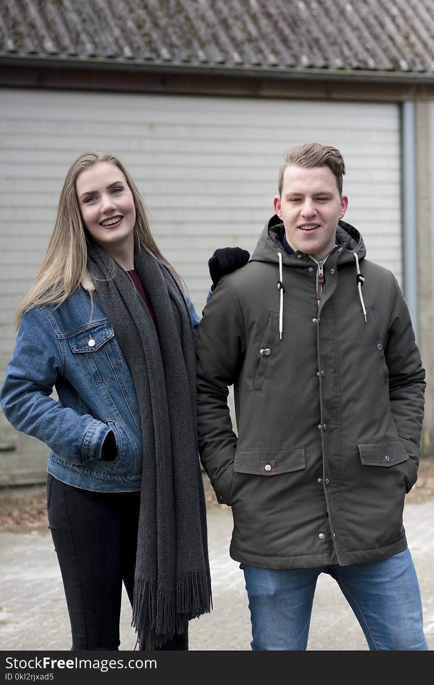 Man Wearing Black Coat and Woman Wearing Blue Denim Jacket