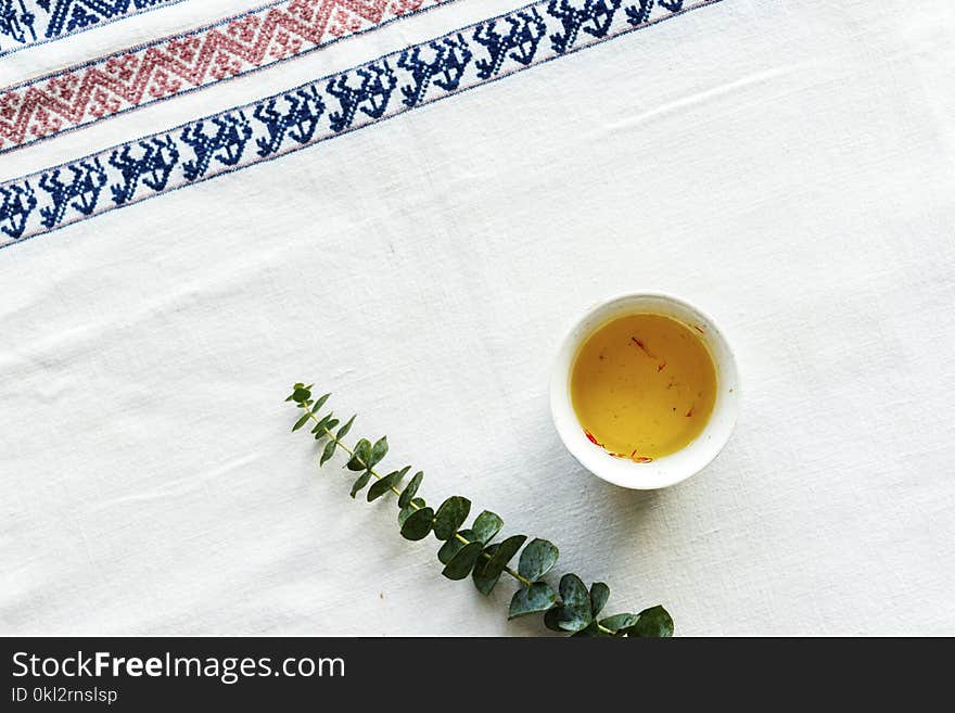 Green Leafed Plant Beside Sauce on White Table Mat