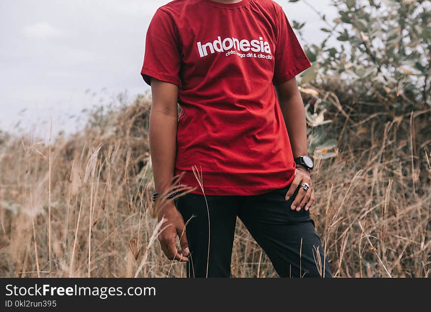 Man in Red Crew-neck T-shirt Beside Grasses