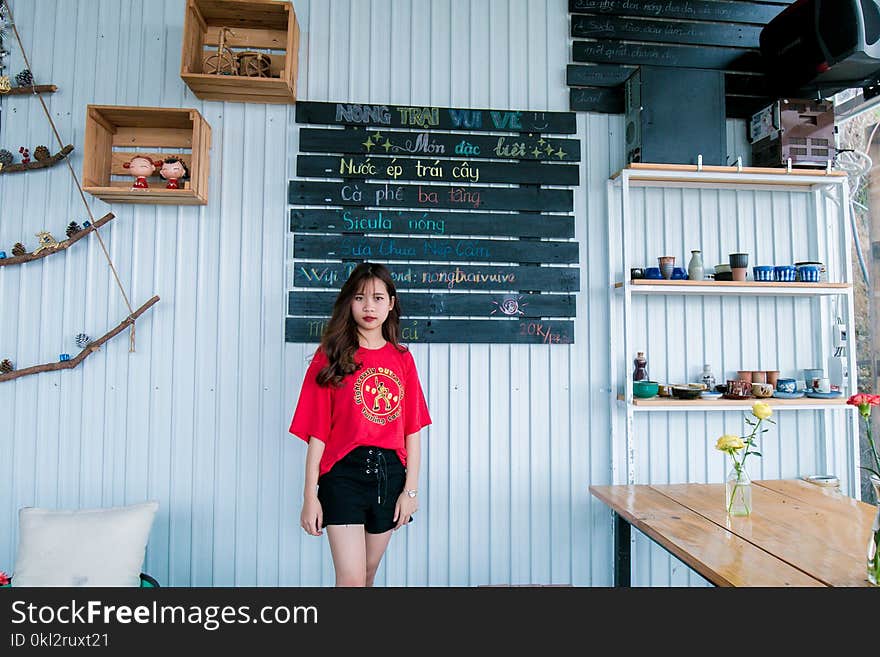 Woman in Red Crew-neck T-shirt and Black Short Shorts