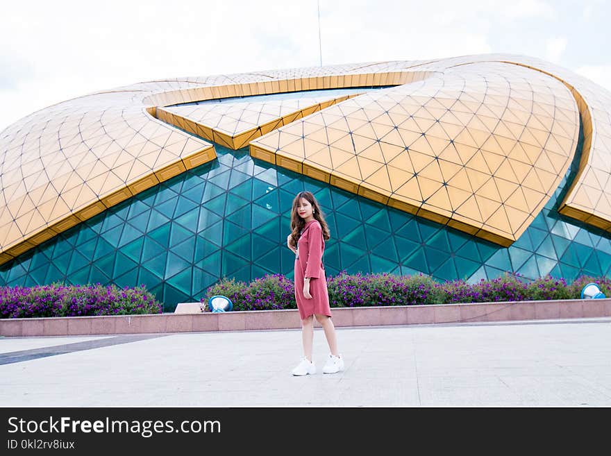 Photo of Woman Wearing Pink Long-sleeved Dress