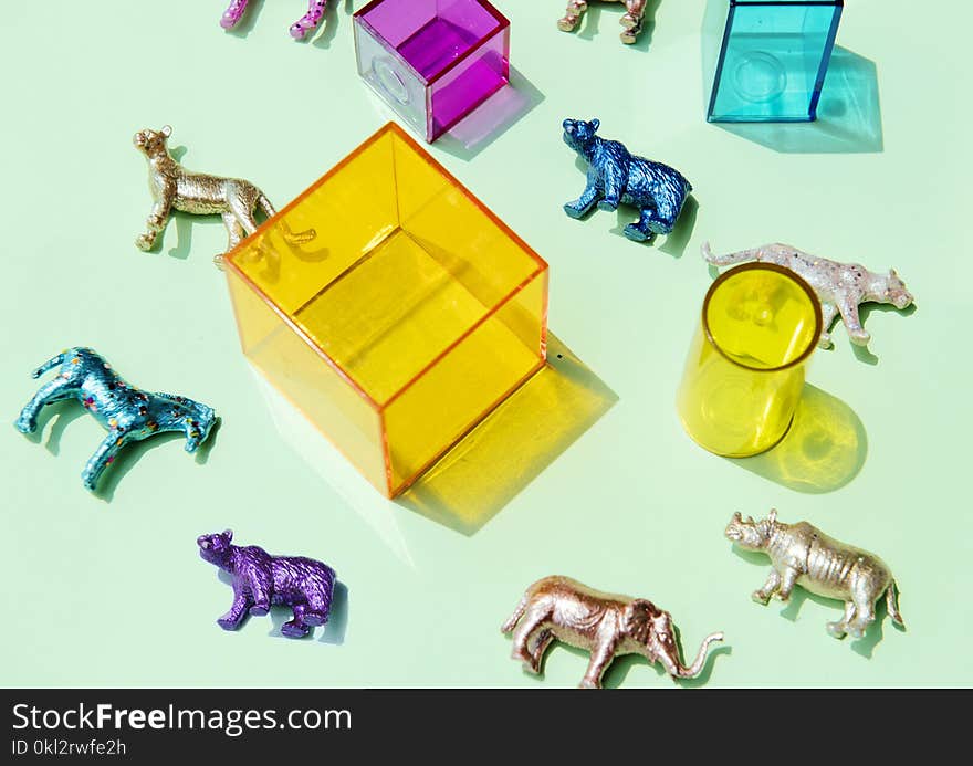 Assorted-color Animal Figurines Near Container