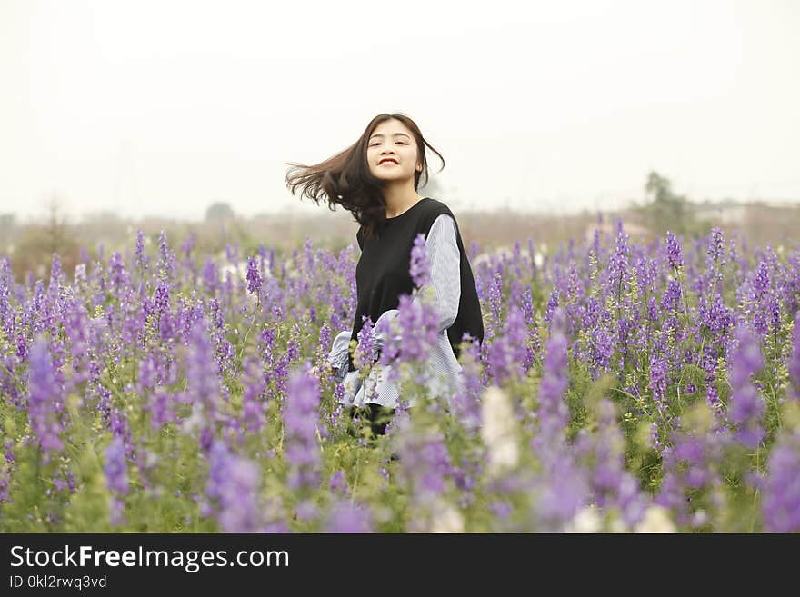 Woman With Black and White Long-sleeved Top on Garden