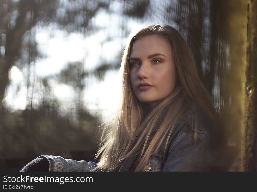 Woman Wearing Gray Denim Jacket by the Wall