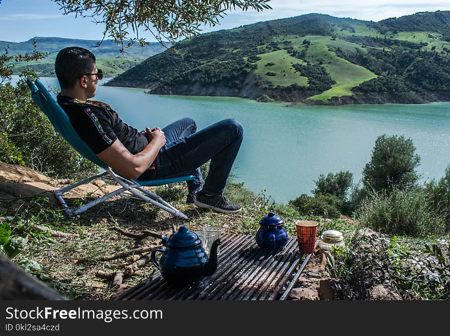 Man Sitting Overlooking Lake