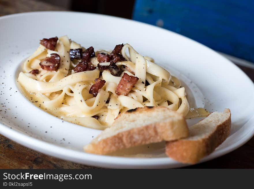 Pasta Dish With Bread on White Ceramic Plate