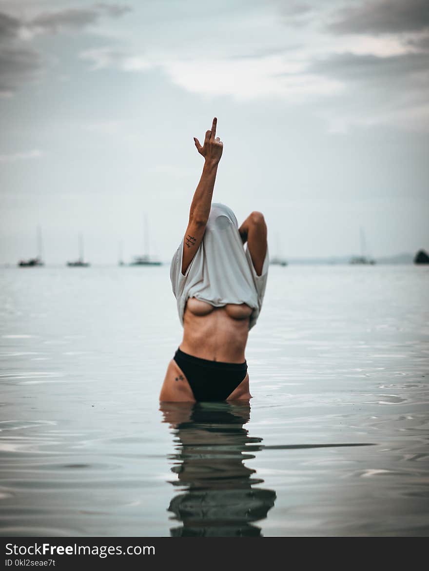 Woman Wearing White Shirt Raise His Middle Finger