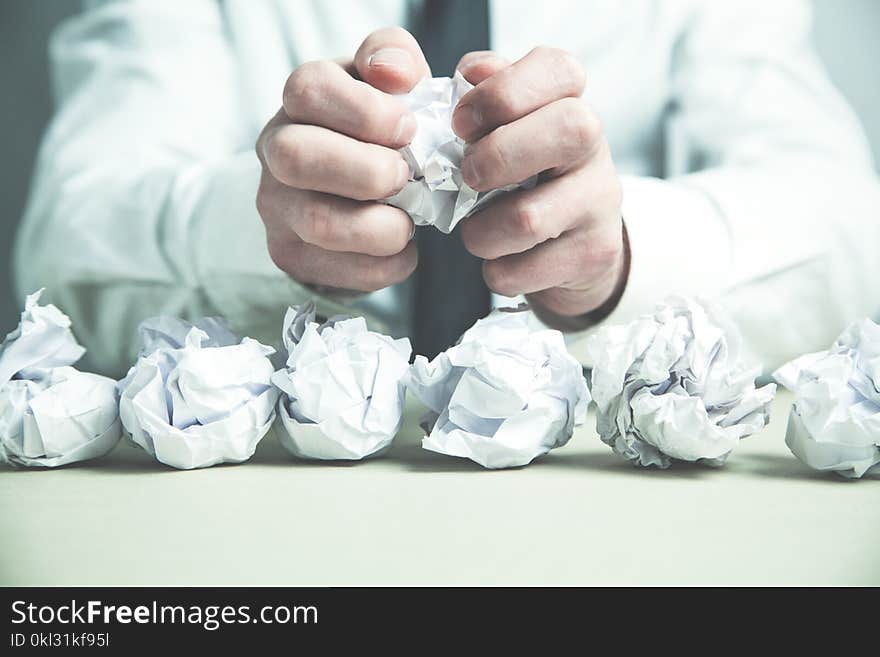 Crumpled paper on man hands.