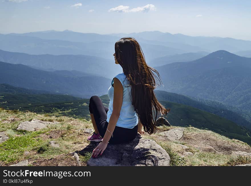 Girl with long hair on top of the mountain, on the background of the Carpathian Mountains, on a warm summer day. Girl with long hair on top of the mountain, on the background of the Carpathian Mountains, on a warm summer day