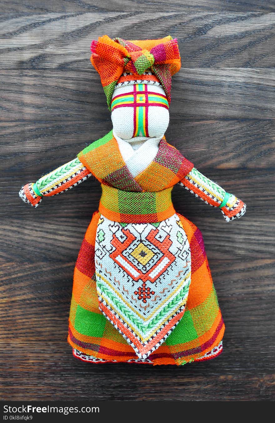 Motanka doll on the wooden background