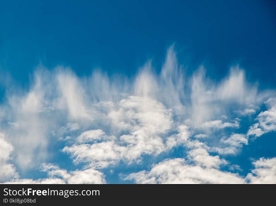 White color clouds found in the blue sky background