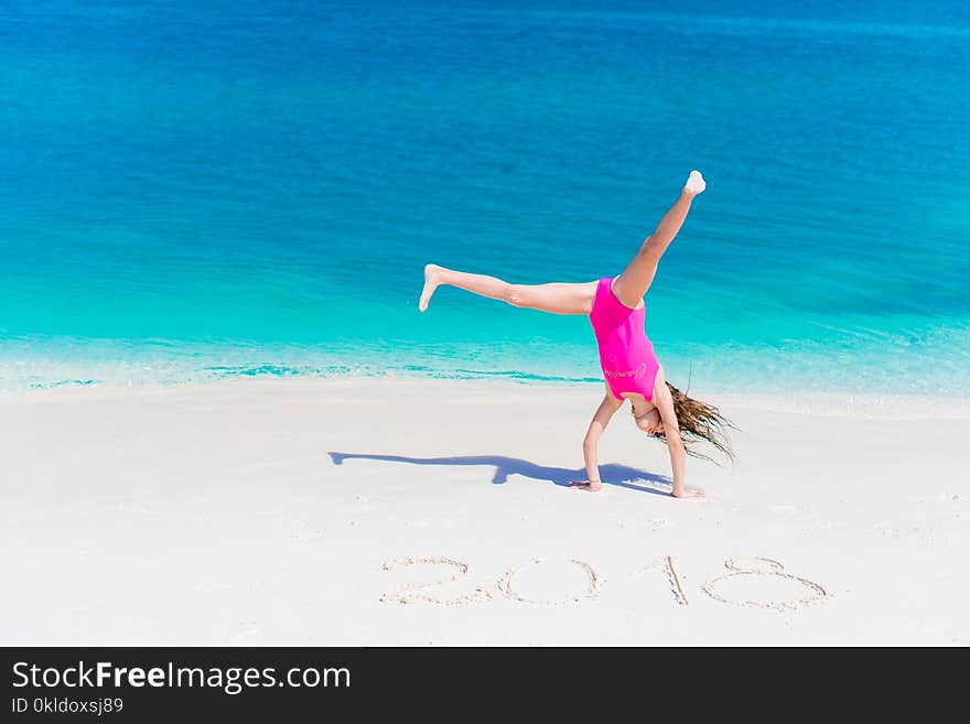 Cute little girl in hat at beach during caribbean vacation