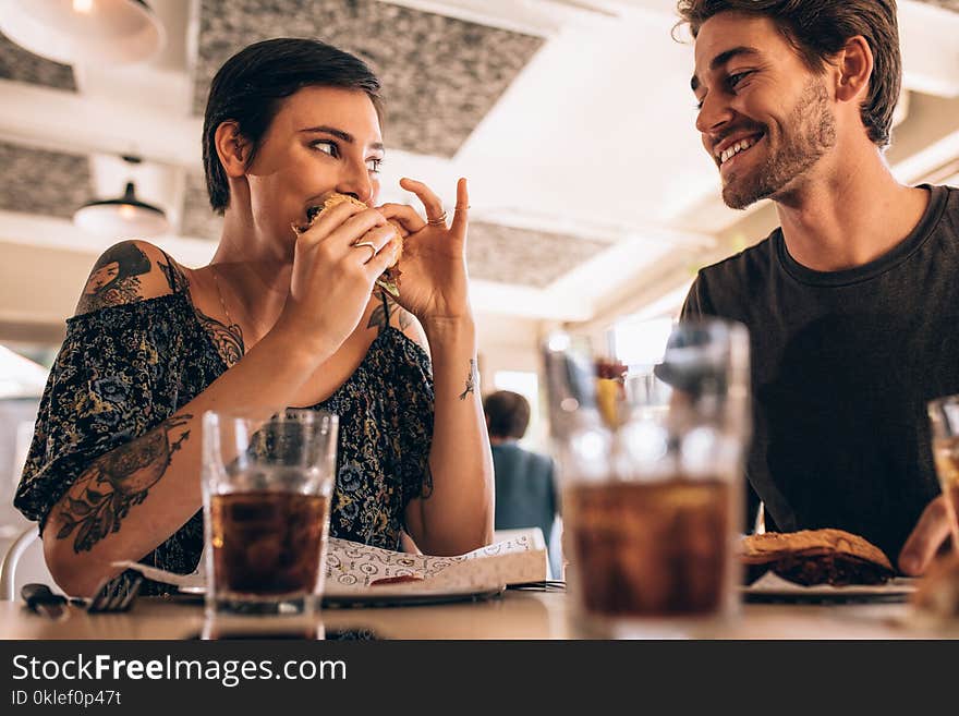 Couple at restaurant having burger